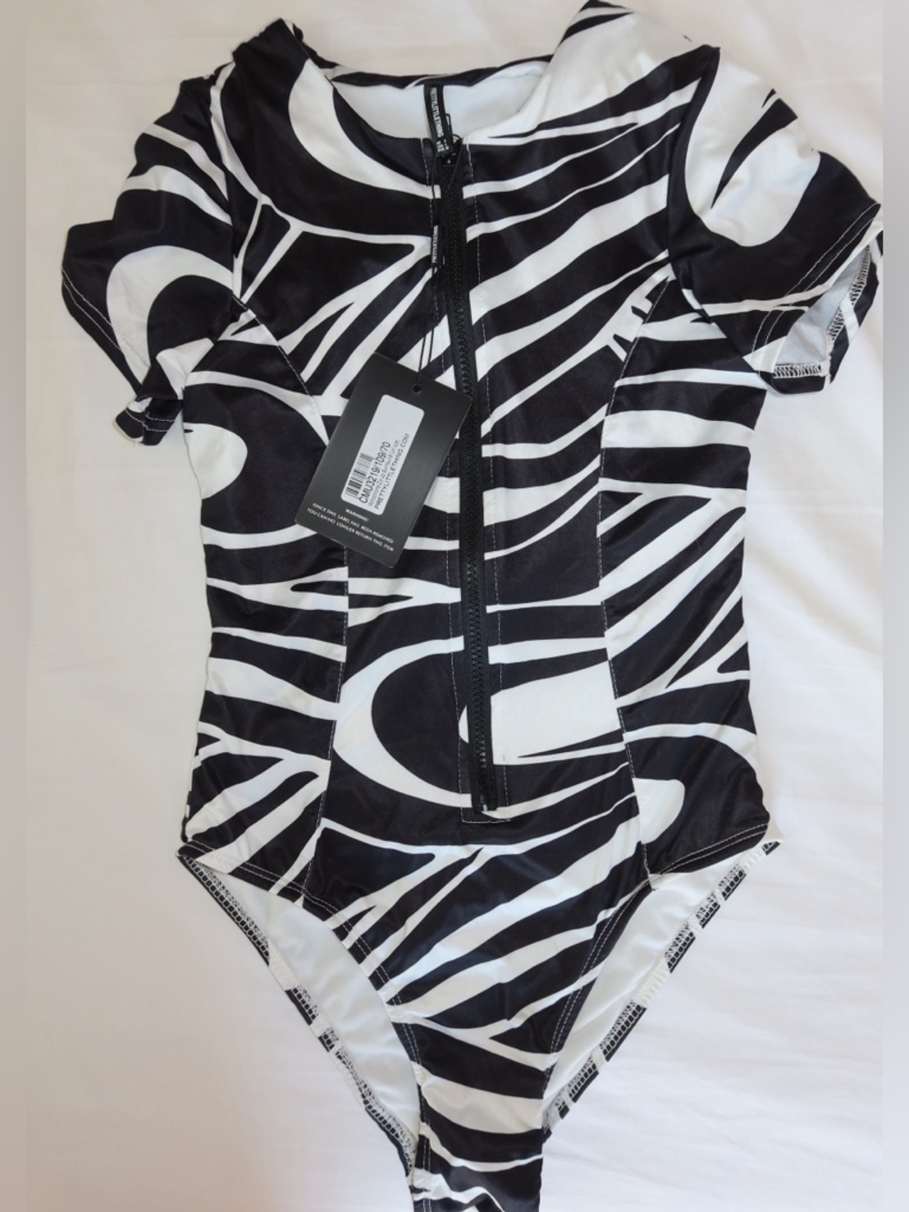 Pretty Littlw Thing Monochrome Zip Up Swimsuit 
Size US 4 
NEVER WORN WITH TAGS